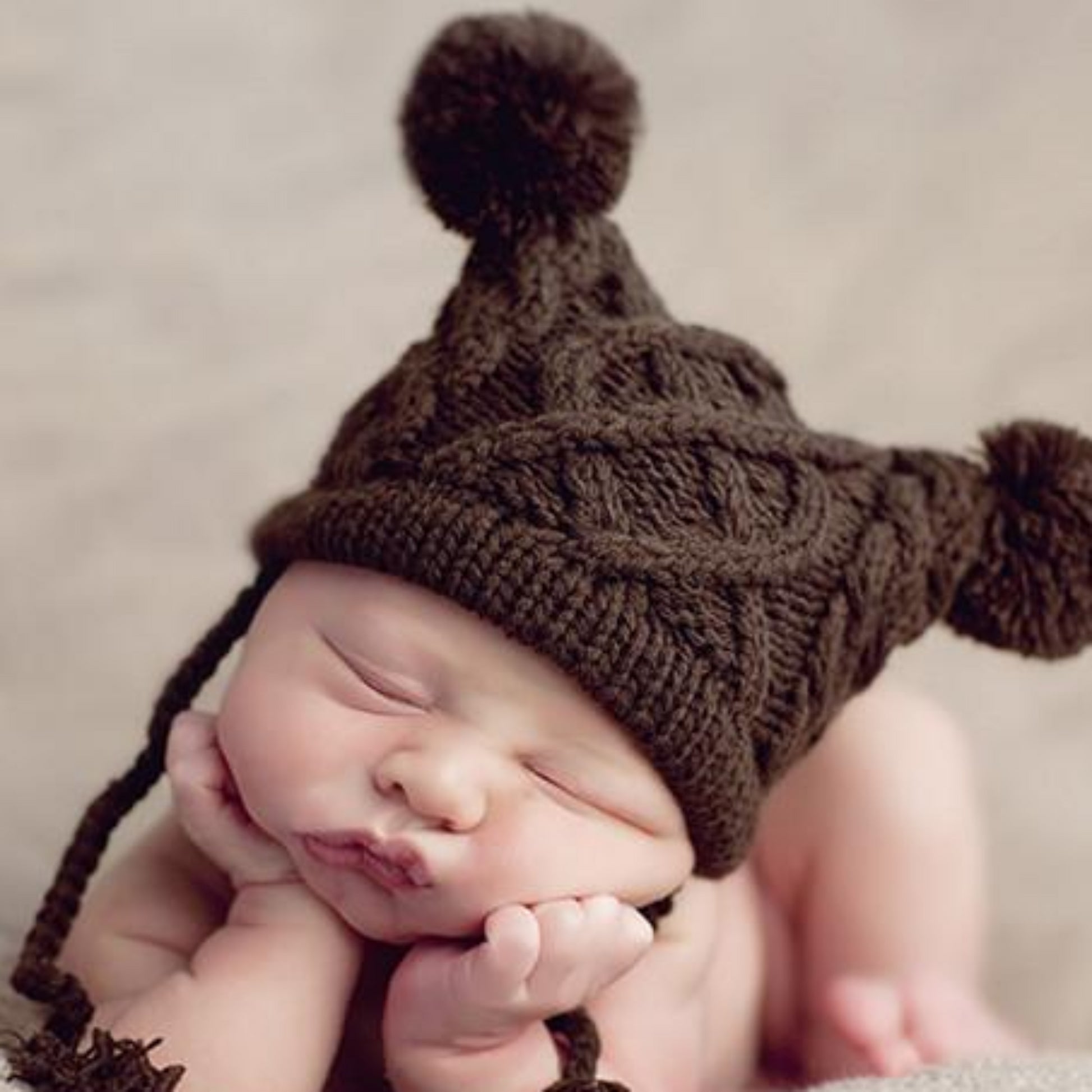 cable knit hat for baby with poms and tassels brown