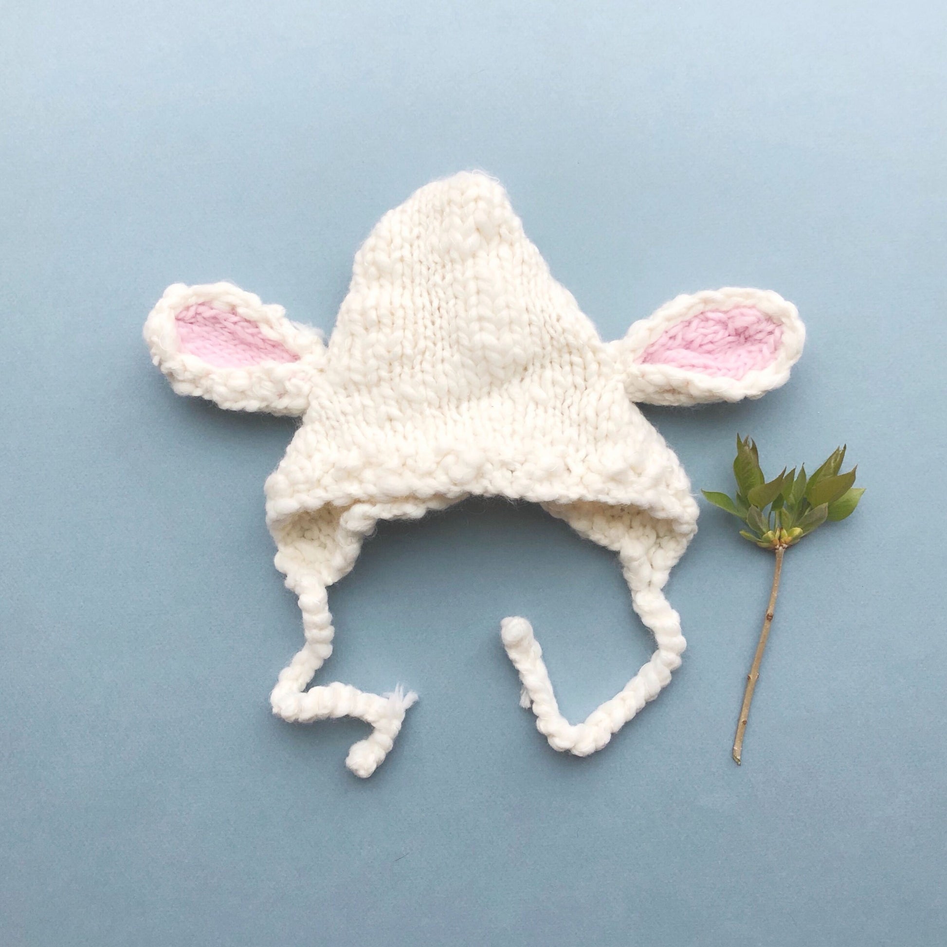 hand knit lamb bonnet for baby in cream with pink ears