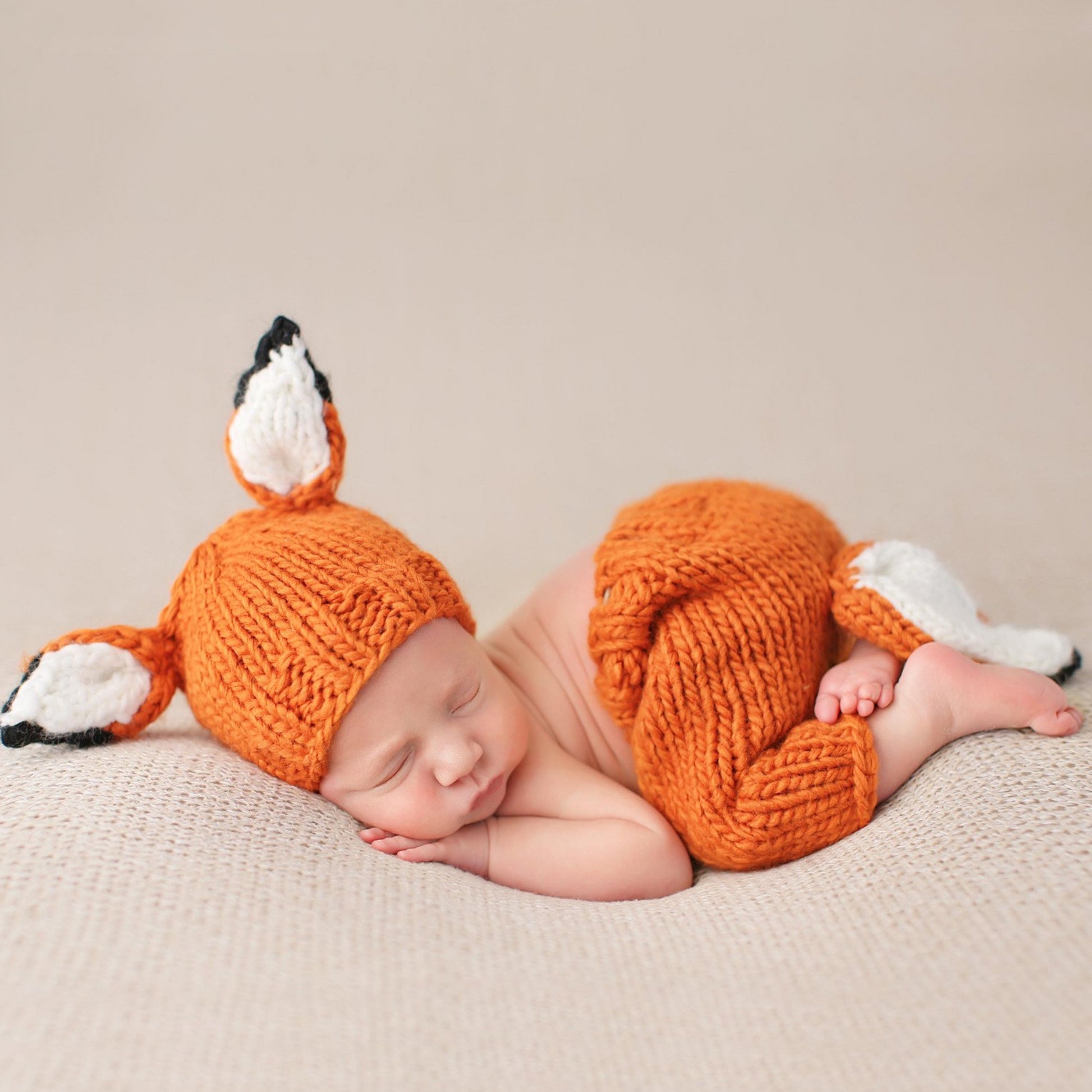 hand knit orange fox hat and pants set for baby with white ears and tail