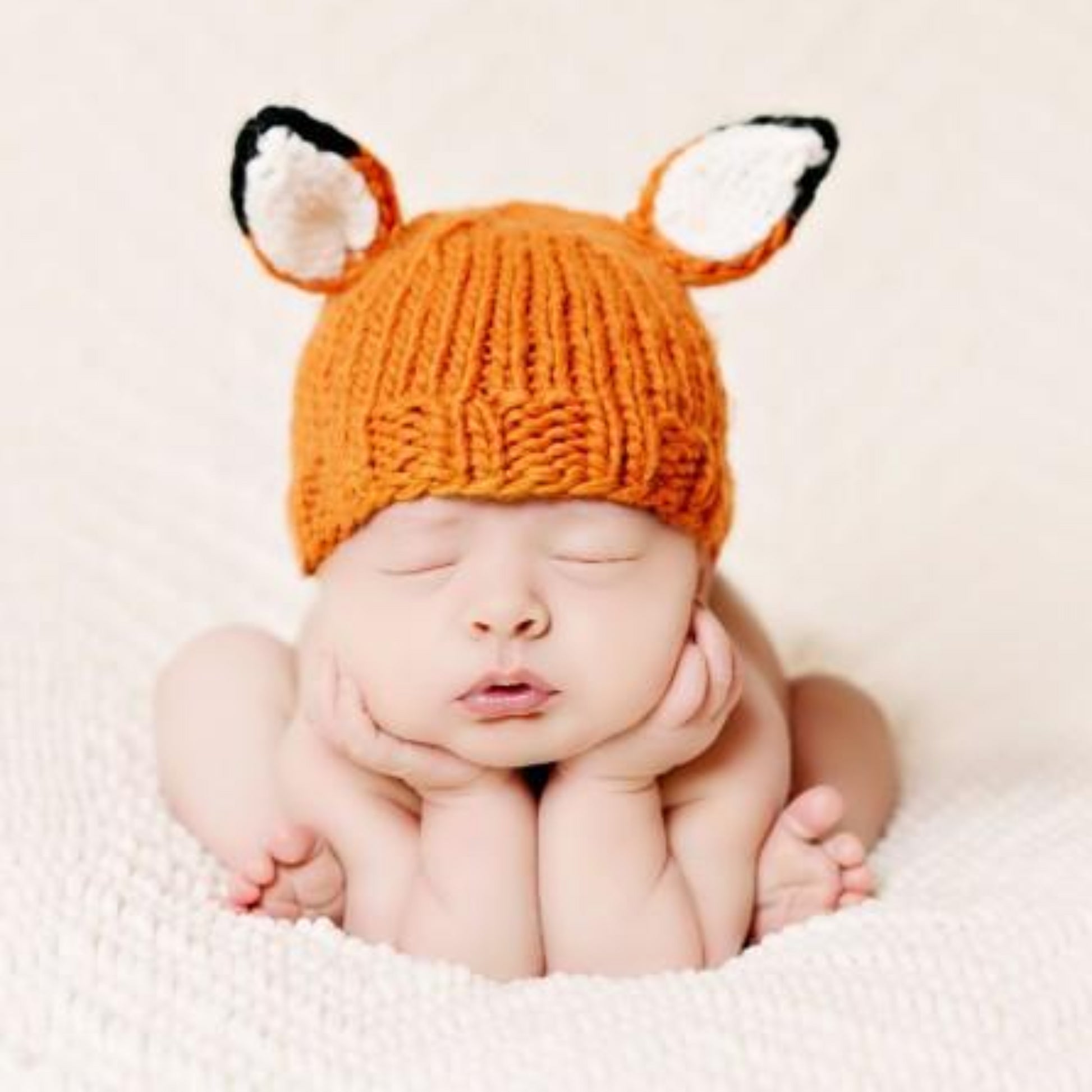 hand knit orange fox hat and pants set for baby with white ears and tail
