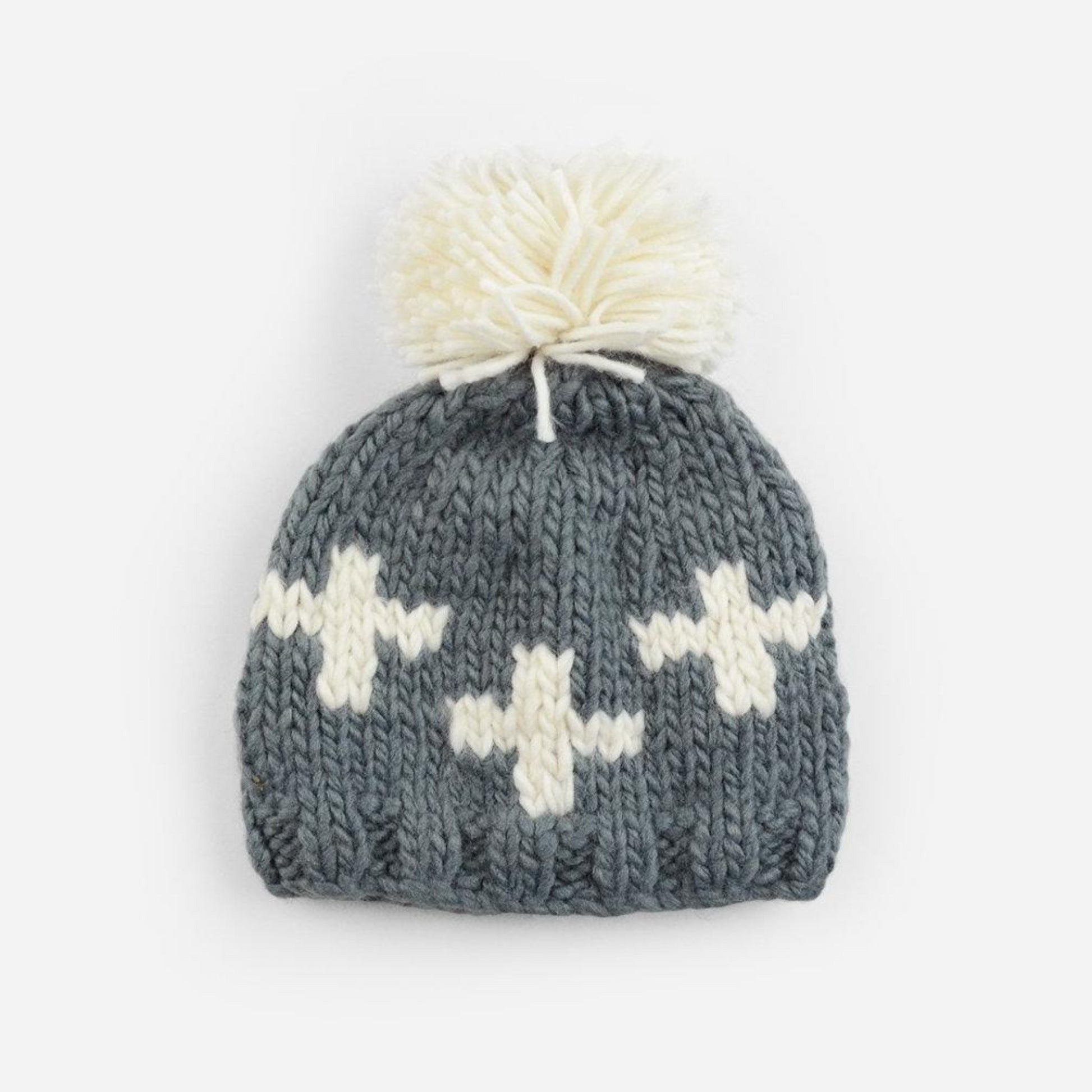 gray hand knit beanie with white pom and and swiss cross pattern